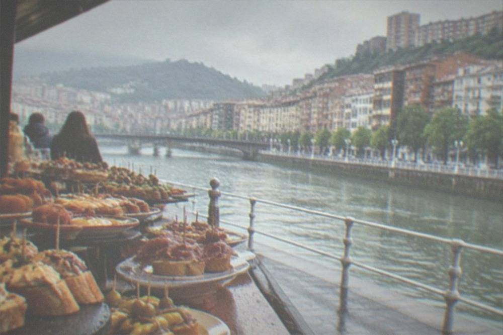 A pintxos bar counter in Bilbao loaded with small plates and skewers