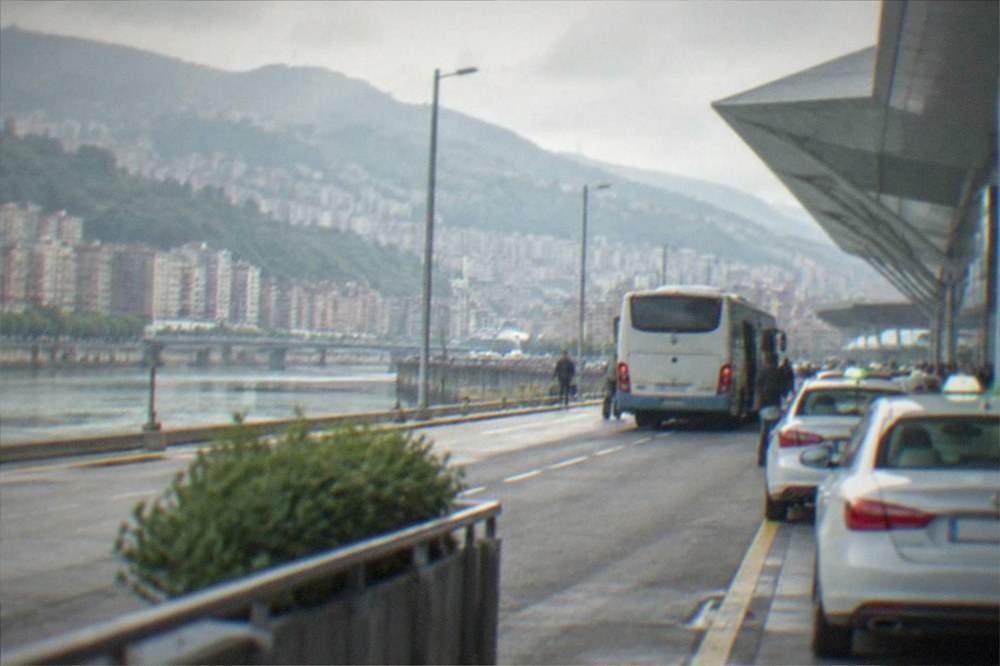 Bilbao Airport terminal forecourt with buses and taxis waiting at the kerb