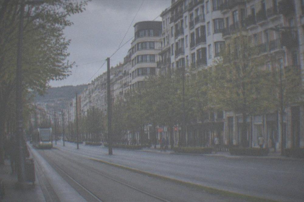 The flat wide Gran Via street in Bilbao's Ensanche district with modern buildings and a tram track in the foreground