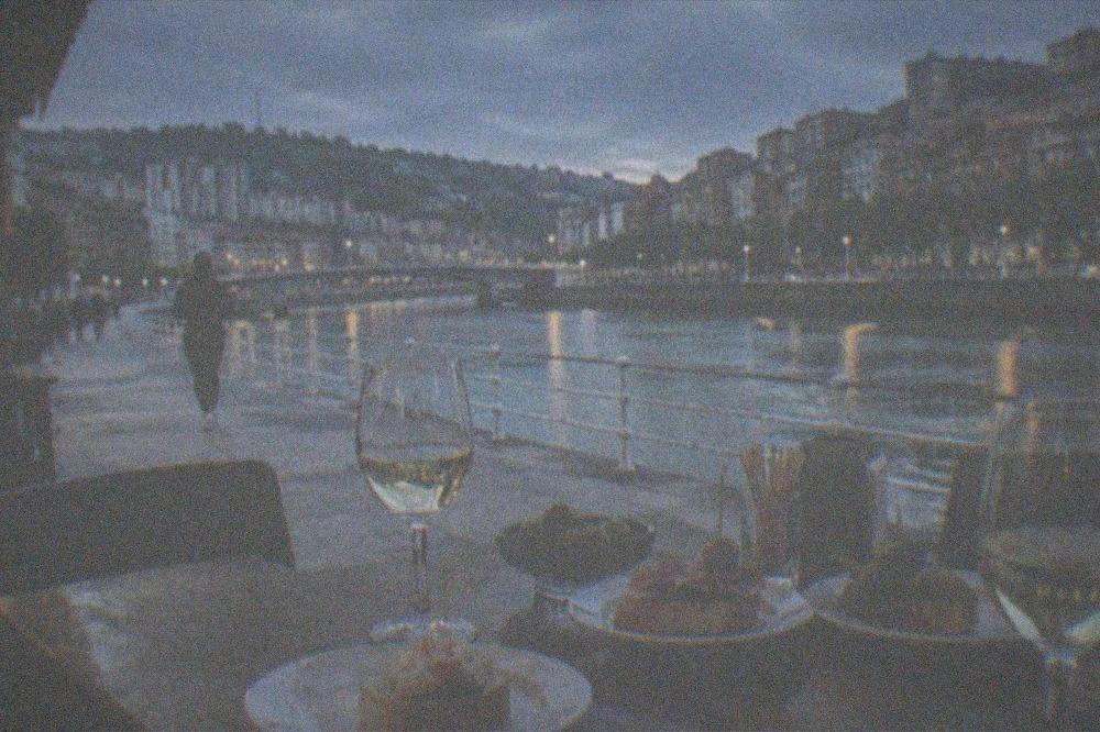 A table at a Bilbao restaurant with pintxos plates, glasses of wine and a bill on the table