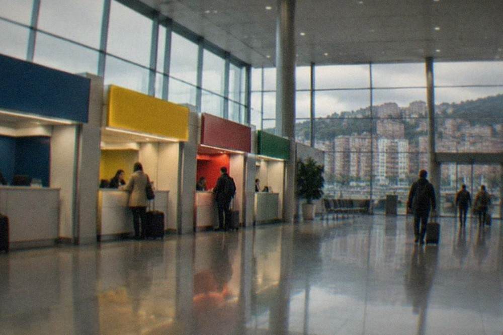 Rental car desks inside the bright arrivals hall of Bilbao Airport