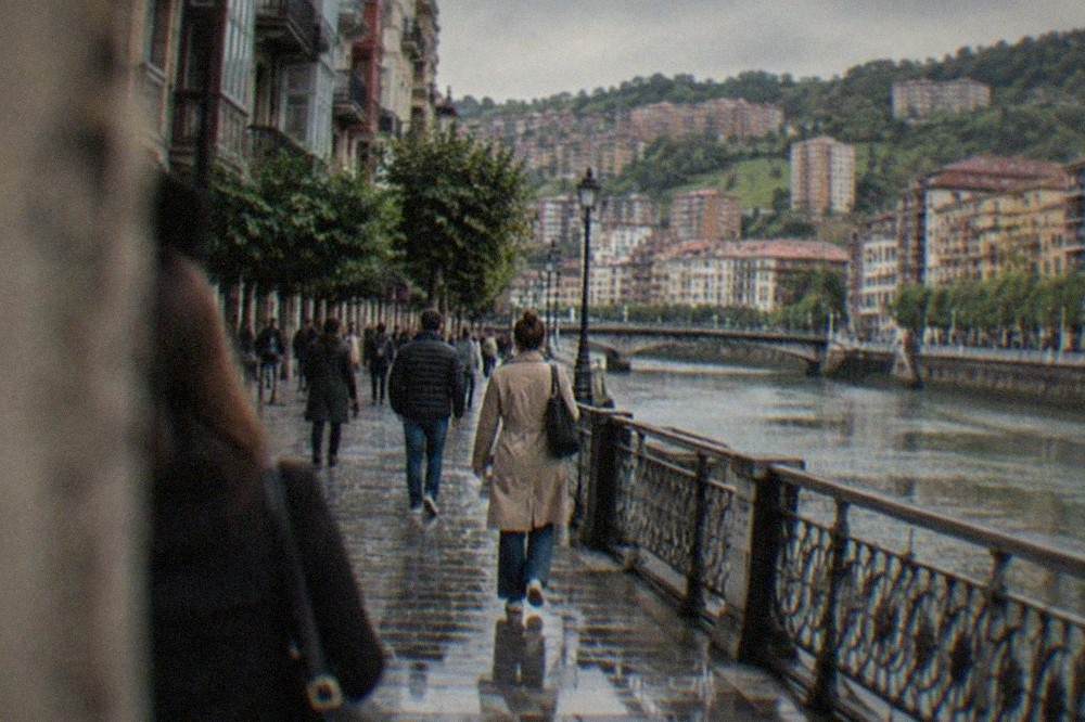 People walking through a busy pedestrian street in Bilbao's Old Town during the day