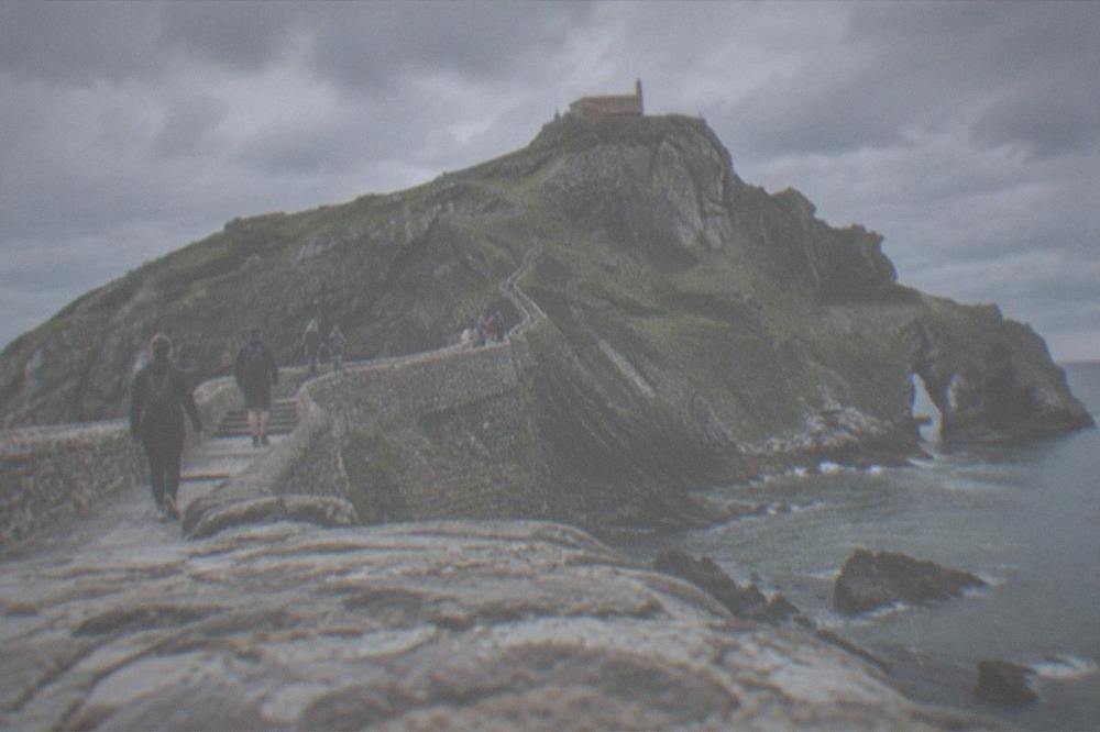 Walkers on the stone stairway crossing to the hermitage islet of San Juan de Gaztelugatxe