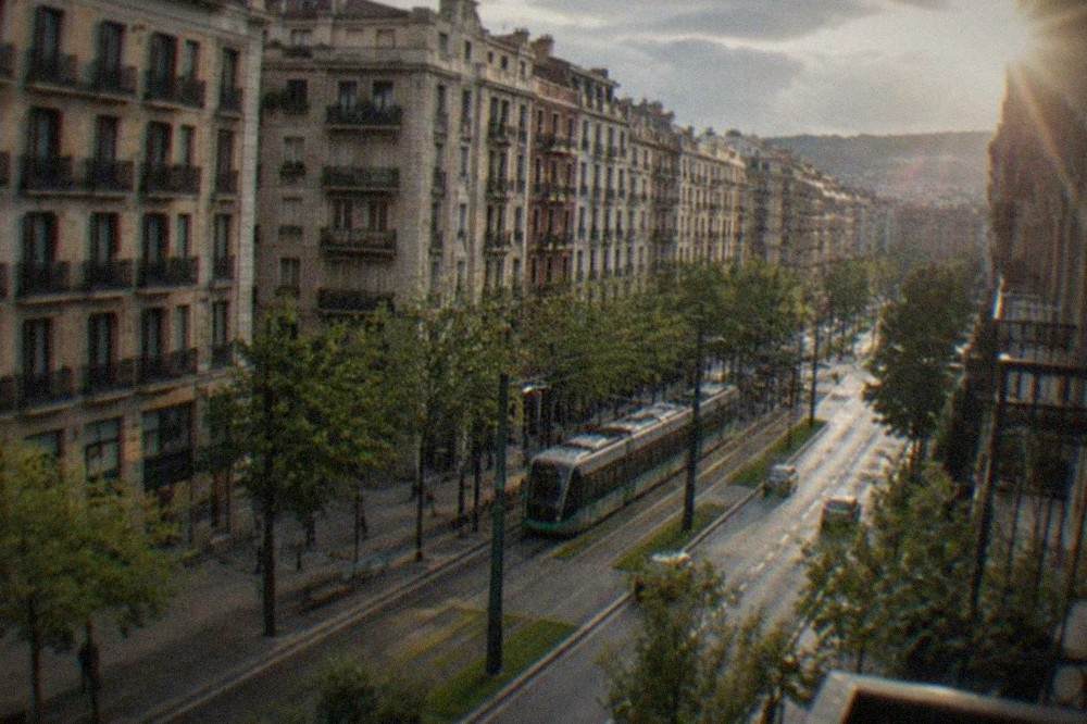 A wide Bilbao street with apartment buildings and a tram line in the Ensanche district