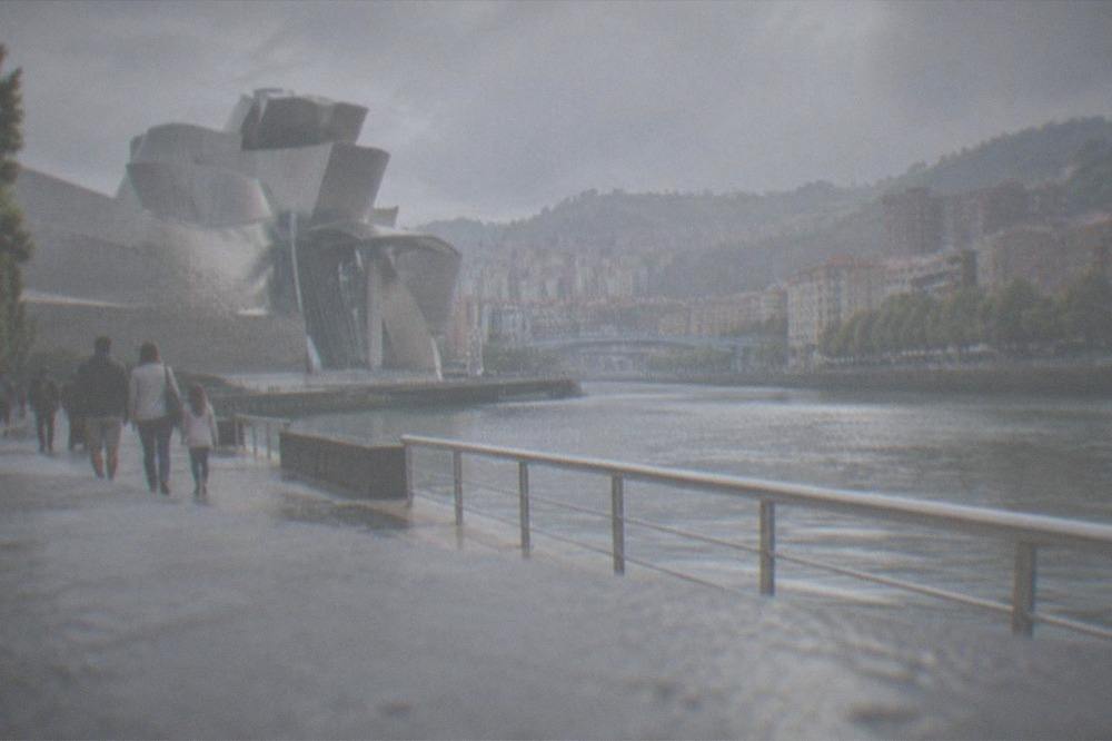Families walking along the flat riverside promenade beside the Guggenheim in Bilbao