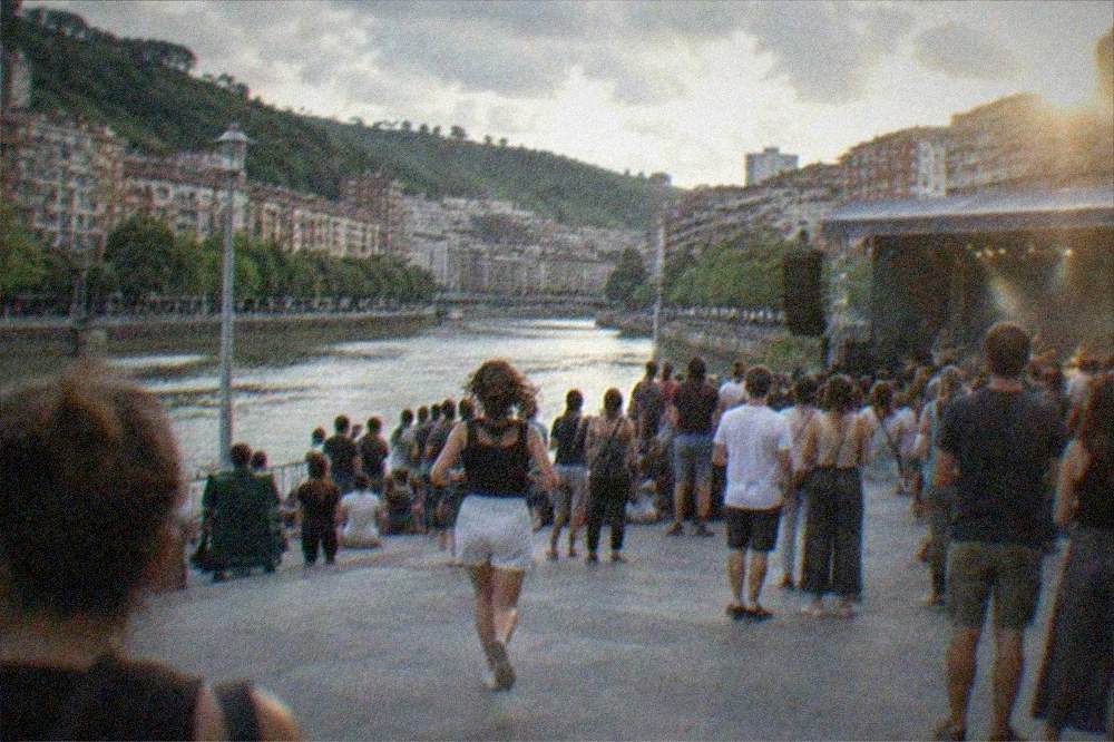 Crowds watching an evening concert in a Bilbao square during a summer festival