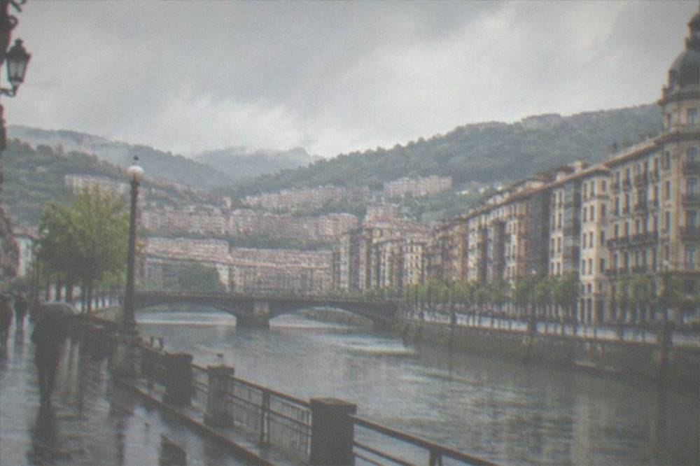 The Gran Via in Bilbao lined with stone bank buildings and a domed corner tower