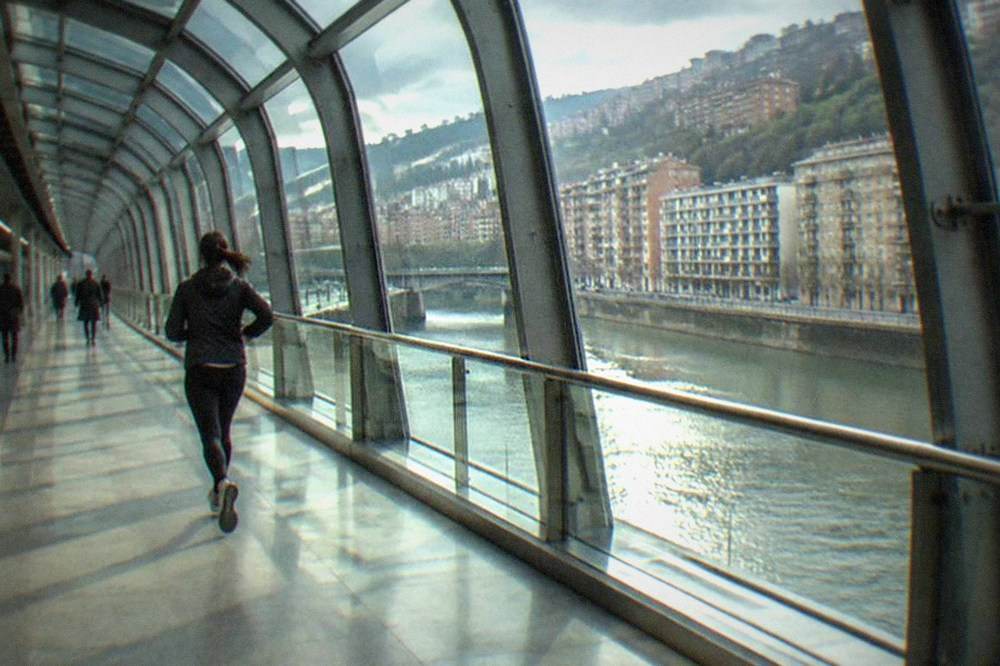 A curved metro station interior with steel and glass design in Bilbao