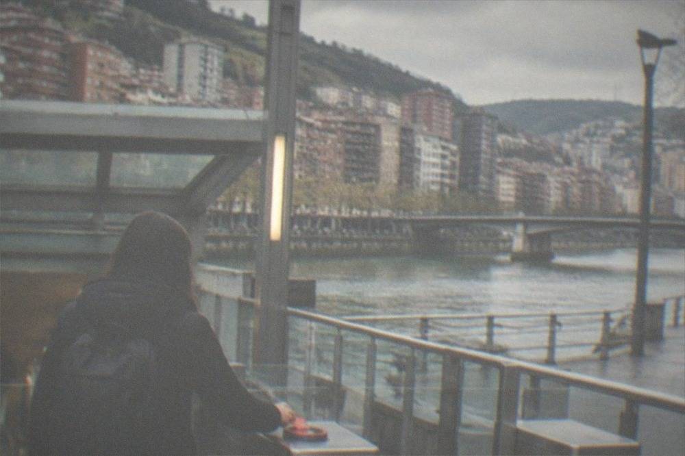 A metro station entrance in Bilbao with a traveller tapping a Barik card at the validator