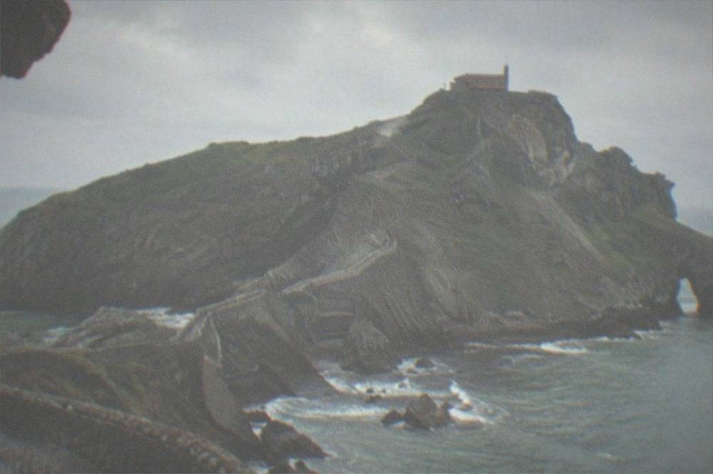 The rocky islet of San Juan de Gaztelugatxe with its stone causeway under a grey sky