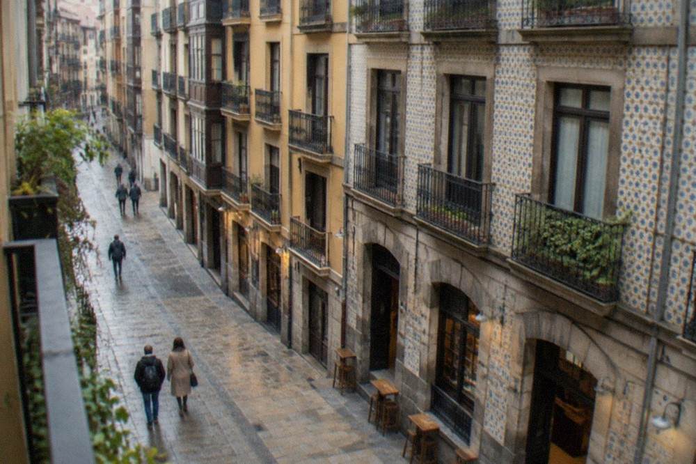 A narrow street of tiled facades in Bilbao's Seven Streets old quarter