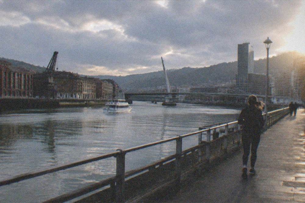 Evening light on the Nervion river with Bilbao bridges and buildings reflected