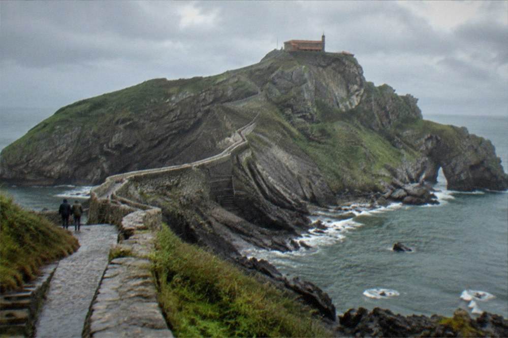 The stone causeway and steps to San Juan de Gaztelugatxe under a moody grey sky on the Basque coast