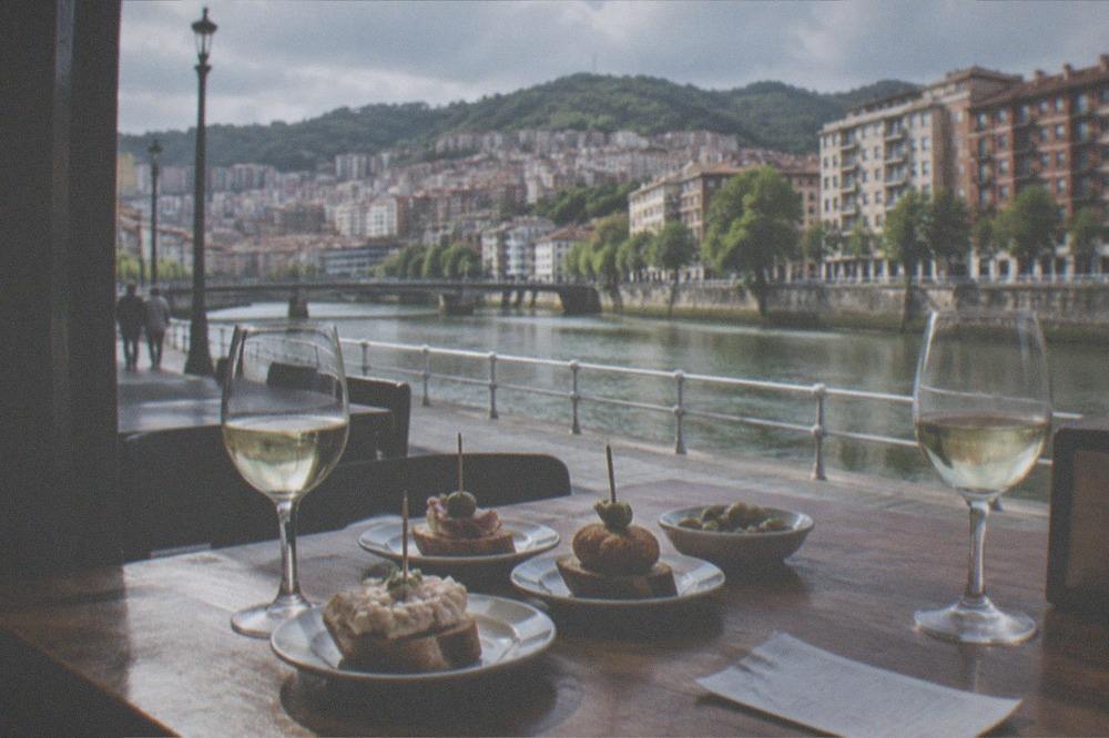 A table with pintxos, glasses of txakoli wine and a bill at a Bilbao bar
